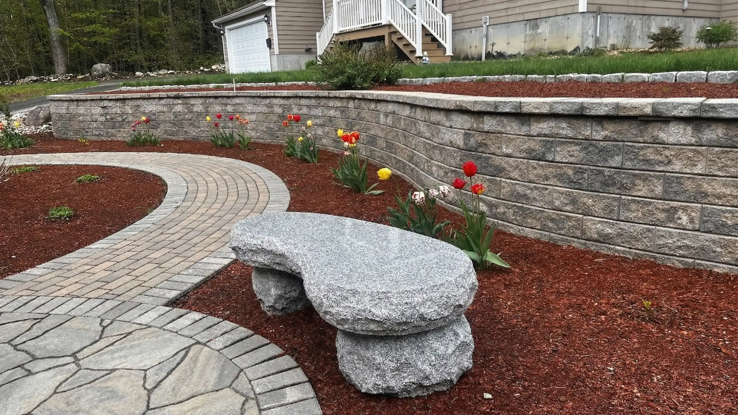 Custom retaining walls and walkway with plantings built by Outdoor Lifestyles